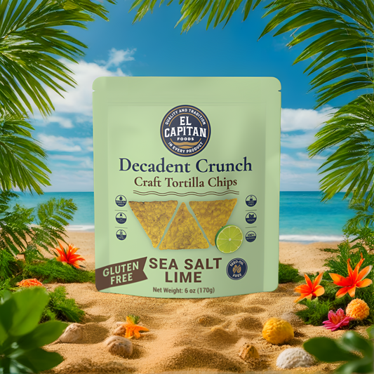 El Capitan Foods Decadent Crunch lime tortilla chips with sea salt on a beach background